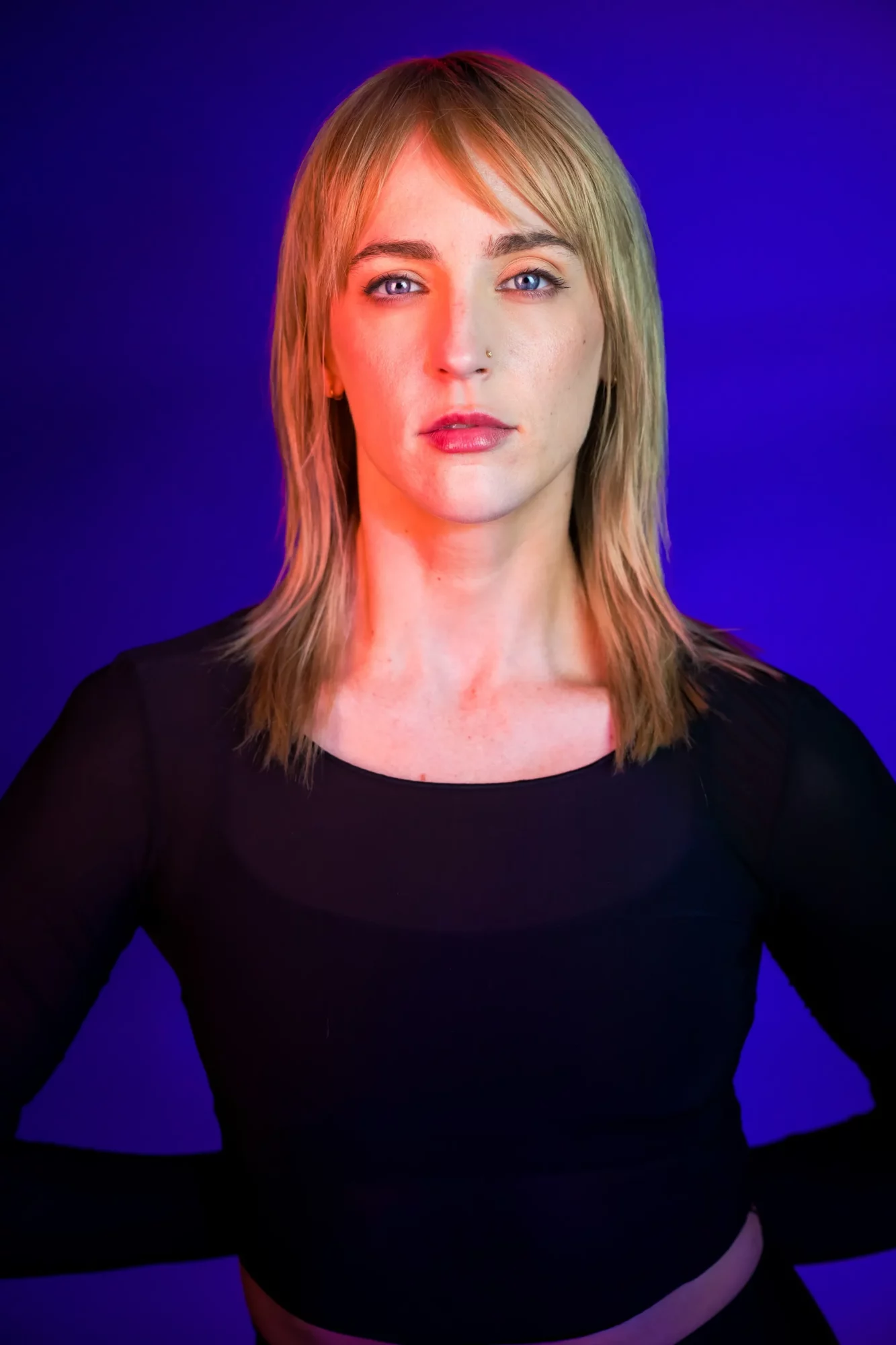 Professional headshot of Alex Lyons, VP of Brand Marketing at JETSET Pilates, against a vibrant blue and purple backdrop